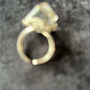 Petty ring with large crystal square stone. Adjustable steel band .